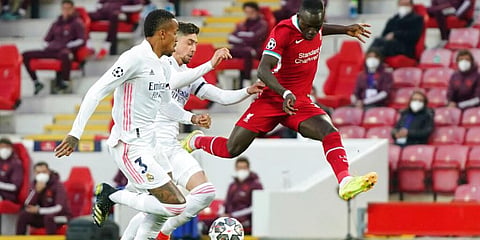 Liverpool's Sadio Mane fights for the ball with Real Madrid's Federico Valverde (C) and Eder Militao. (Photo | AP)