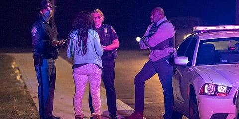 IMPD spokesperson Genae Cook speaks with a person looking for information on the people inside the FedEx building where multiple people were reportedly shot in Indianapolis. (Photo | AP)