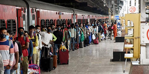 Migrants stand in a queue to give the samples for COVID-19 testing amid the rise in cases, at Patna Junction railway station. (Photo| ANI)
