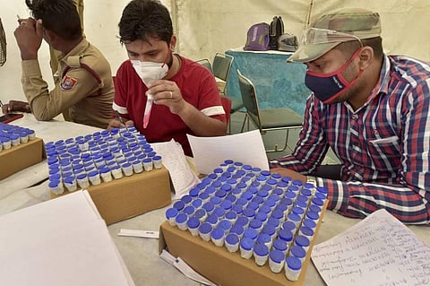 Health workers arrange swab samples after testing passangers at ISBT Anand Vihar, during weekend lockdown imposed in the wake of rising Covid-19 cases across the country, in New Delhi. (Photo | PTI)