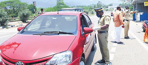 Police checking those arriving in private vehicles for e-passes and Covid negative certificates at the Walayar checkpost on Monday