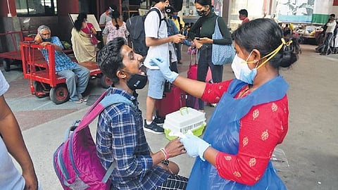A health worker takes a swab sample from a man in Bengaluru on Monday | EXPRESS 