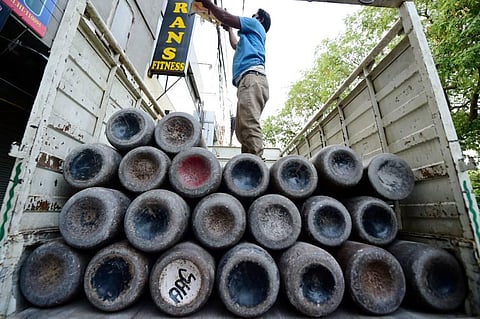 Workers load empty cylinders of medical oxygen, required for treatment of critical COVID-19 patients, as coronavirus cases surge across the country (Photo | PTI)