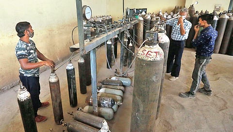 Workers fill cylinders with medical oxygen at an oxygen plant in New Delhi (Photo | Shekhar Yadav)