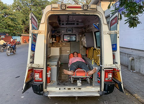 A COVID-19 patient receives primary treatment inside an ambulance at the COVID-19 OPD of the Government Civil Hospital, in Ahmedabad. (Photo | PTI)