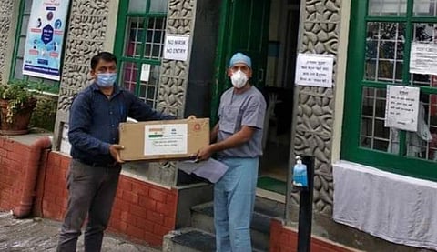 Binu George handing over the donation to the Landour Community Hospital (LCH) in Mussoorie. (Photo | Special arrangement)