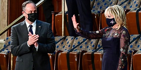 First lady Jill Biden waves as she arrives prior to President Joe Biden arriving to address a joint session of Congress, as Doug Emhoff looks on. (Photo | AP)