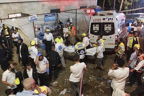 Israeli security officials and rescuers carry a body of a victim who died during a Lag Ba'Omer celebrations at Mt. Meron in northern Israel, Friday, April 30, 2021. (Photo | AP)