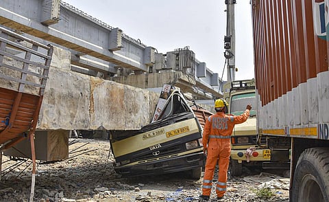NDRF personnel carry out rescue works after a portion of an under-construction railway bridge collapsed in Rampura area of New Delhi. (Photo | PTI)