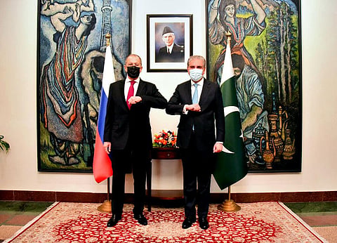 Pakistan's Ministry of Foreign Affairs, Russia's Foreign Minister Sergey Lavrov, left, bumps elbows with his Pakistani counterpart Shah Mahmood Qureshi. (Photo | AP)