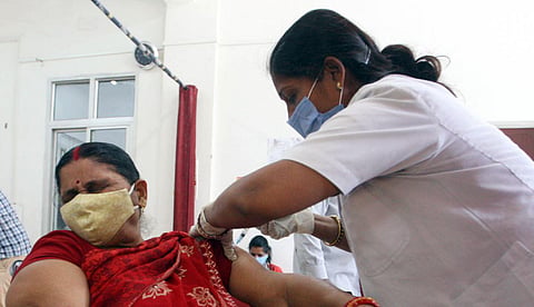 A woman receives a dose of Covishield, a coronavirus disease vaccine, in Prayagraj on Tuesday. (Photo | ANI)