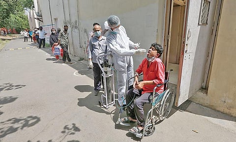 Sample being taken for Covid test from a wheelchair-bound patient. (Photo | SHEKHAR YADAV, EPS)
