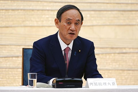 Japanese Prime Minister Yoshihide Suga announces that Tokyo, Kyoto and Okinawa will be applied for pre-emergency status under a new prevention law. (Photo | AP)