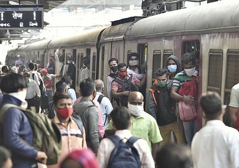 Commuters board a crowded train as authorities permitted all members of the general public to travel in local trains. (Representational Photo | PTI)