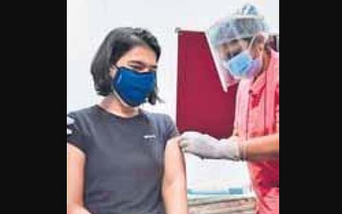 A health staffer vaccinates a young woman at KC General Hospital in Bengaluru on Monday | Shriram BN