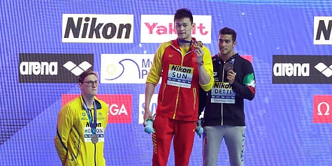 China's Sun Yang (C) holds up his gold medal as silver medalist Australia's Mack Horton (L) stands away from the podium after the men's 400m freestyle final at the WSC in Gwangju. (Photo | AP)