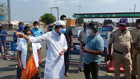 Kurnool MLA Hafeez Khan requesting Telangana police to allow ambulances at AP-TS border at Pullur toll plaza in Kurnool district. (Photo | Express)