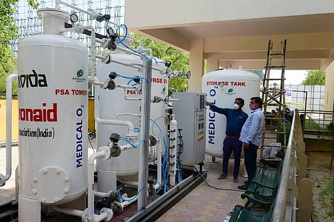 Engineers inspect an oxygen plant at a 50 bedded COVID-19 care centre, at a stadium in Noida. (Photo | PTI)