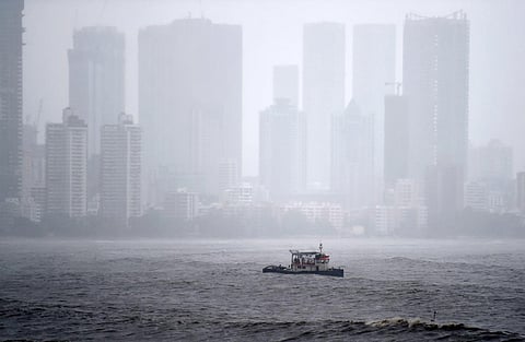 A boat ventures into the Arabian sea surrounded by heavy rain and wind during the formation of cyclone Tauktae, at Bandra in Mumbai. (Photo | PTI)