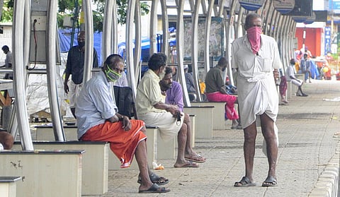 Homeless people waiting at the East Fort bus terminal for free food being distributed by the NGOs. A scene on day one of the triple lockdown. (Photo | B P Deepu, EPS)