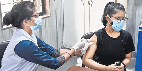 A beneficiary above 18 years old gets the COVID vaccine at a government school on Tuesday. (Photo | Parveen Negi, EPS)