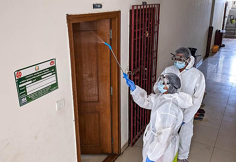 Corporation workers santizing an apartment  at Ayanambakkam in Chennai. (Photo | Debadatta Mallick, EPS)