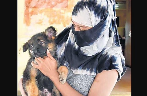 A woman with her puppy at a veterinary hospital in Tiruchy | M K Ashok Kumar