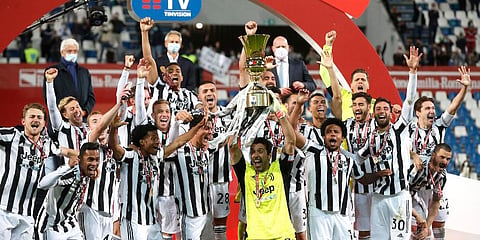 Juventus players celebrate with the winner's trophy their victory against Atalanta after the end of Italian Cup soccer final match at the Mapei Stadium in Reggio Emilia. (Photo | AP)