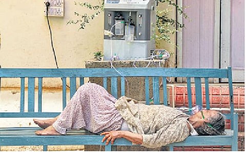 A Covid-19 patient receives oxygen from a makeshift arrangement outside a government hospital in Jammu on Wednesday | pti