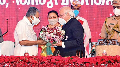 Governor Arif Mohammad Khan presents a bouquet to Pinarayi Vijayan after the latter took oath of office on Thursday.