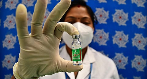 A health official displays a Covishield vaccine. (Photo | Shriram BN, EPS)