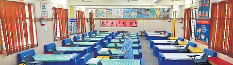 Workers prepare a Covid care centre set up by the South Delhi Municipal Corporation at a primary school at PTS Colony in Malviya Nagar in New Delhi on Monday | Shekhar Yadav