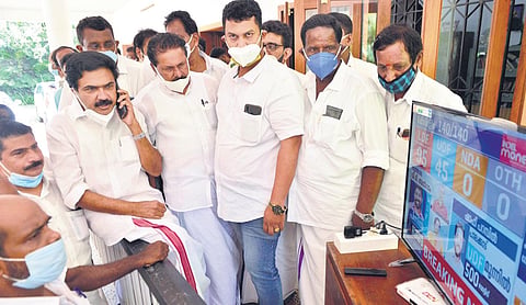 KC(M) chairman Jose K Mani watches the live election updates on television along with a group of party workers at his residence in Pala on Sunday | Express