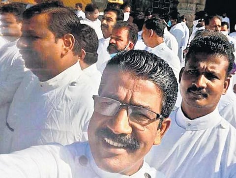 Priests at the retreat without facemasks and not maintaining social distancing.