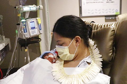 In this undated photo provided by Hawaii Pacific Health, Lavinia 'Lavi' Mounga holds her son Raymond Mounga at Kapiolani Medical Center for Women & Children in Honolulu. (Photo | AP)