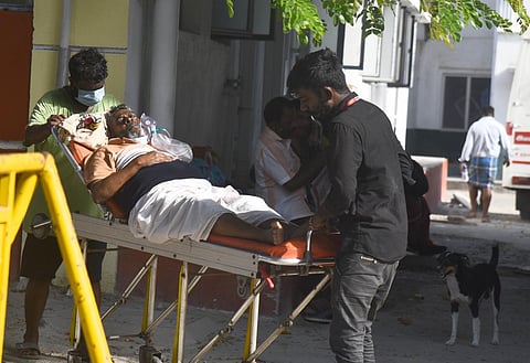 A Covid patient is being carried on a stretcher at KMC in Chennai. Express/ Martin Louis.