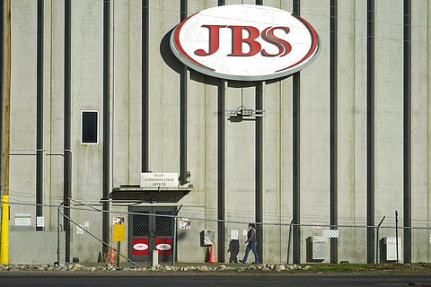 A worker heads into the JBS meatpacking plant in Greeley Colorado. (Photo | AP)