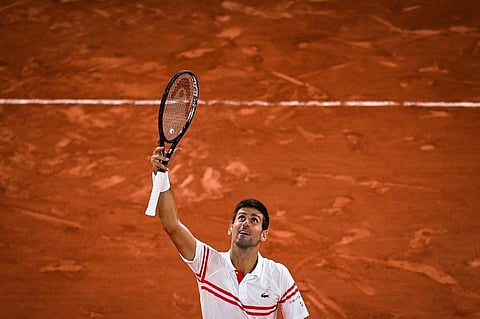 Novak Djokovic celebrates after winning against Rafael Nadal at the end of their men's singles semi-final of The Roland Garros 2021 French Open | AFP