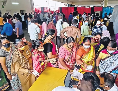 People wait in long queues to get Covid-19 vaccine, during a drive organised by the GHMC, at Tolichowki in Hyderabad on Friday. | RV K Rao