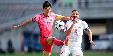 South Korea's Son Heung-min (L) fights for the ball against Lebanon's Kassem El Zein during their Asian zone Group H qualifying match for the FIFA World Cup Qatar 2022 at Goyang Stadium. (Photo | AP)