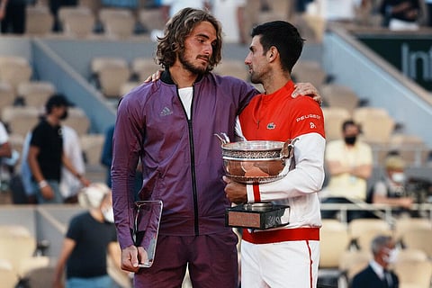 Serbia's Novak Djokovic, right, and Stefanos Tsitsipas of Greece hug while holding their trophies after their final match of the French Open tennis tournament. (Photo | AP)