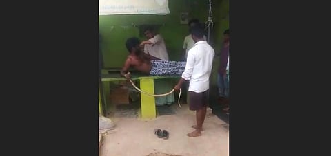 Farmer Kadappa who was bitten form cobra came to hospital with snake in Ballari. (Photo | Express)