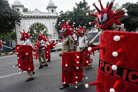 Hyderabad City Police personnel, equipped with Coronavirus-themed helmets, shields, and maces, organised a programme to create awareness on Covid-19, in front of the Assembly. (Photo | Vinay Madapu, E