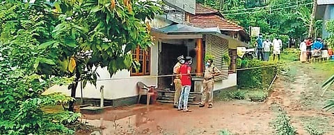 Policemen and people gathered in front of the house of Drishya