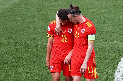 Wales' forward Gareth Bale (R) consoles Ethan Ampadu as he leaves pitch after receiving a red card during match against Italy at Olympic Stadium, Rome on June 20, 2021. (Photo | AFP)