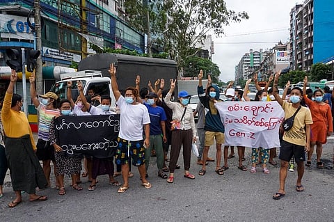 Protesters make the three-finger salute as they take part in a demonstration against the military coup in Yangon on June 22, 2021. (Photo | AFP)
