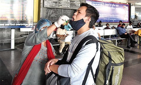 A health worker collects swab samples for Covid testing. (Photo| EPs/parveen negi)