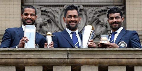Indian cricketers Shikhar Dhawan (L), MS Dhoni (C) and Ravindra Jadeja pose for pictures with the ICC Champions Trophy in Birmingham. (Photo | AFP)