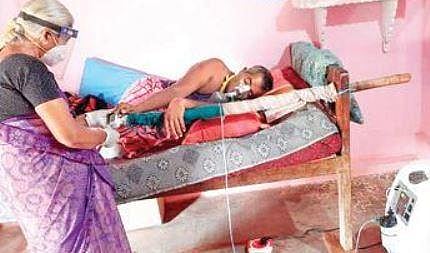 66-year-old Geetha interacts with a patient in  a remote village in Hanur taluk of Chamarajanagar