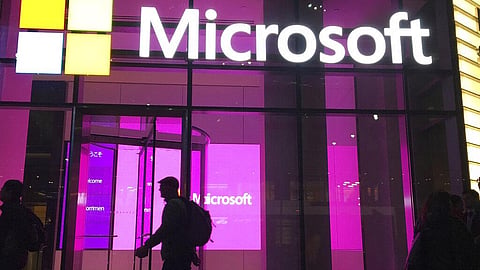 In this Nov. 10, 2016, file photo, people walk near a Microsoft office in New York.